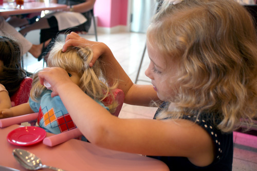 Aut-holding-dolls-hair-drink