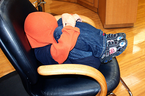 Nathan-covering-head-in-chair